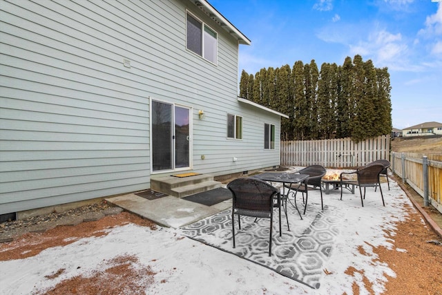 view of patio with an outdoor fire pit and fence