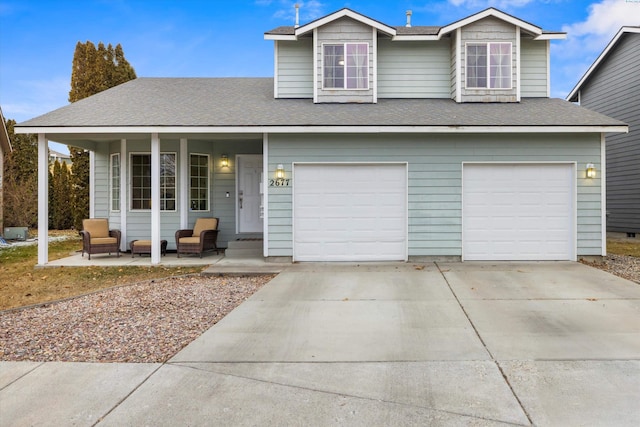 view of front of home featuring an attached garage, concrete driveway, and roof with shingles