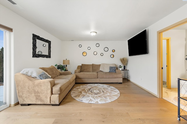 living room with light wood-style flooring and baseboards