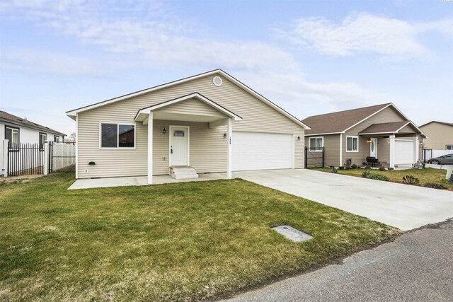 1408 Singh Ln, Sunnyside, WA 98944 - view of front facade featuring a garage and a front lawn