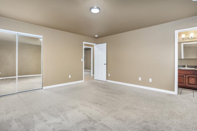 1408 Singh Ln, Sunnyside, WA 98944 - unfurnished bedroom with sink, light colored carpet, a closet, and ensuite bathroom