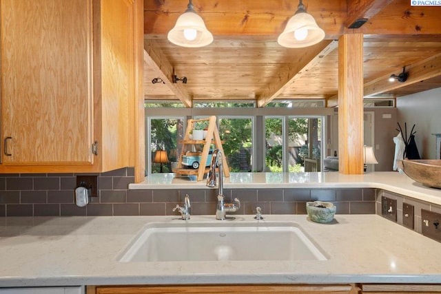 835 SE Spring St, Pullman, WA 99163 - kitchen with a wooden ceiling with exposed beams, tasteful backsplash, hanging light fixtures, and light stone countertops