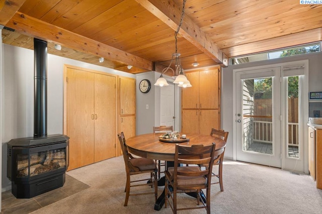 835 SE Spring St, Pullman, WA 99163 - dining area with a wood ceiling with exposed beams, a wood stove, and light colored carpet