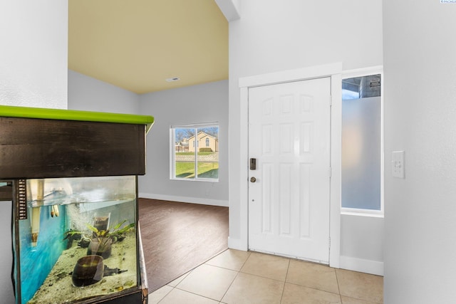 tiled foyer with vaulted ceiling