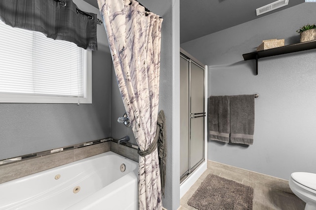 5504 Koufax Ln, Pasco, WA 99301 - bathroom featuring a jetted tub, a stall shower, toilet, baseboards, and tile patterned floors