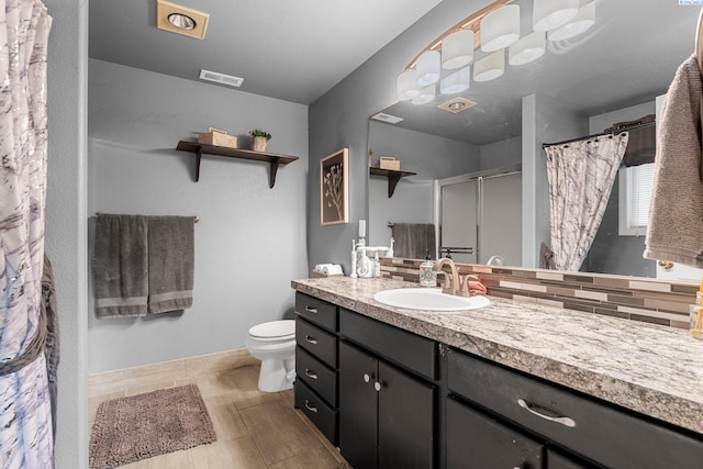 5504 Koufax Ln, Pasco, WA 99301 - full bath featuring vanity, toilet, decorative backsplash, a shower with curtain, and baseboards