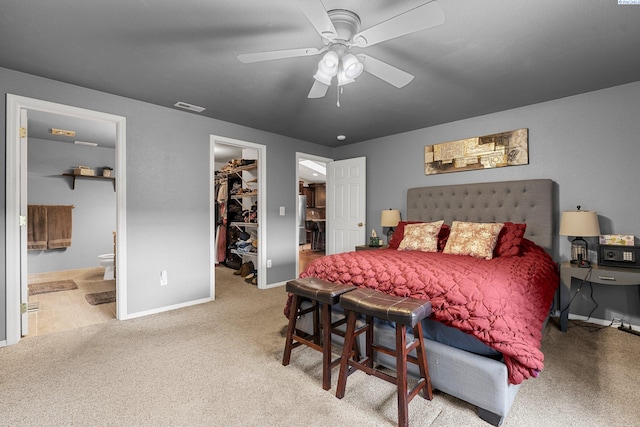 5504 Koufax Ln, Pasco, WA 99301 - carpeted bedroom with a walk in closet, baseboards, a closet, connected bathroom, and a ceiling fan