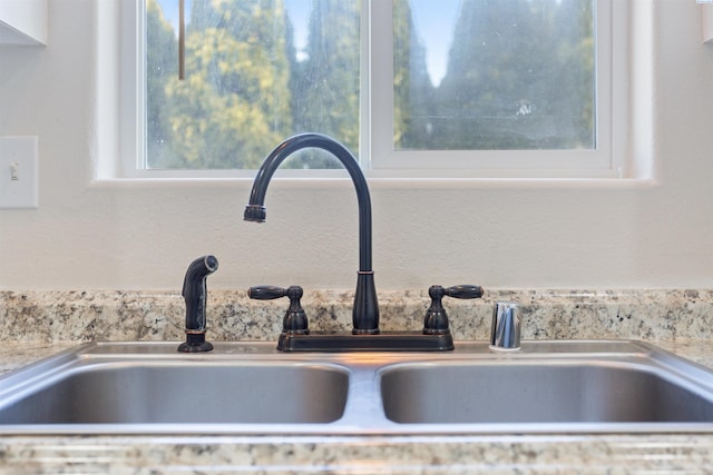 interior details with light countertops and a sink