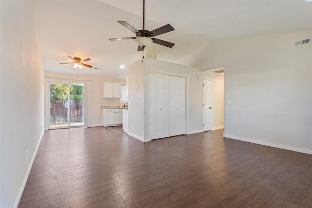 unfurnished living room featuring baseboards, visible vents, dark wood finished floors, a ceiling fan, and lofted ceiling