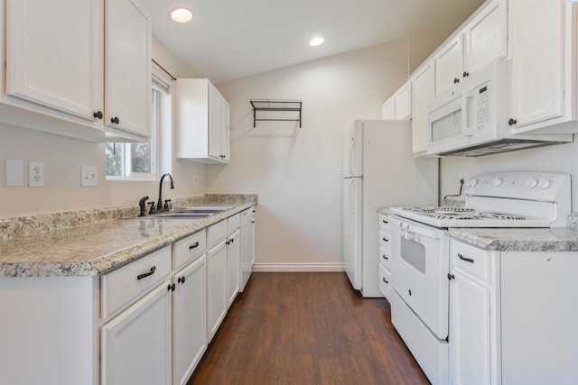 kitchen featuring light countertops, white appliances, a sink, and white cabinets