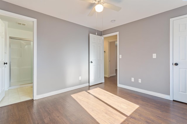 unfurnished bedroom with a ceiling fan, baseboards, visible vents, and dark wood-type flooring