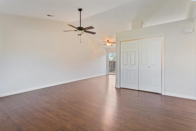 interior space featuring ceiling fan, baseboards, visible vents, and dark wood finished floors