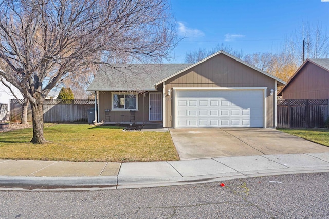 ranch-style house featuring an attached garage, fence, a front lawn, and concrete driveway