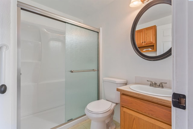 full bathroom featuring tile patterned floors, a shower stall, toilet, and vanity