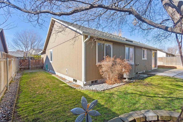 view of side of home with a fenced backyard, central AC unit, and a yard