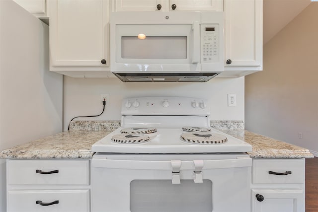 kitchen featuring white appliances, white cabinetry, and light stone countertops