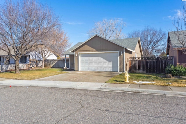 ranch-style home featuring a garage, fence, concrete driveway, and a front yard