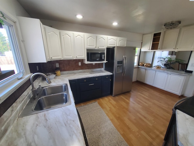 3011 W Hood Ave, Kennewick, WA 99336 - kitchen featuring stainless steel fridge with ice dispenser, black microwave, white cabinetry, light wood-type flooring, and open shelves
