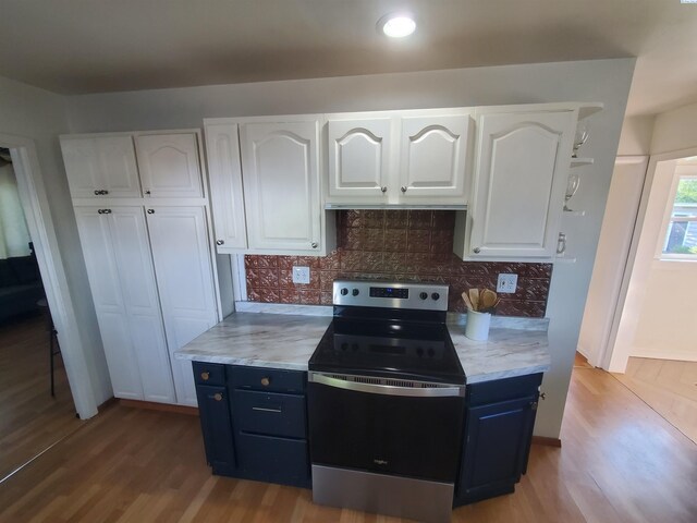 3011 W Hood Ave, Kennewick, WA 99336 - kitchen with electric stove, white cabinetry, wood finished floors, blue cabinetry, and recessed lighting