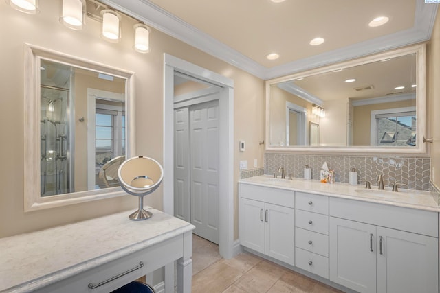 full bath featuring a sink, double vanity, tasteful backsplash, and ornamental molding