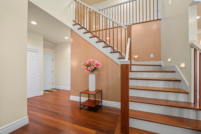 stairway featuring recessed lighting, baseboards, and wood finished floors