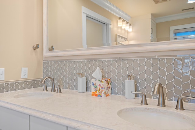 bathroom featuring decorative backsplash, vanity, visible vents, and ornamental molding