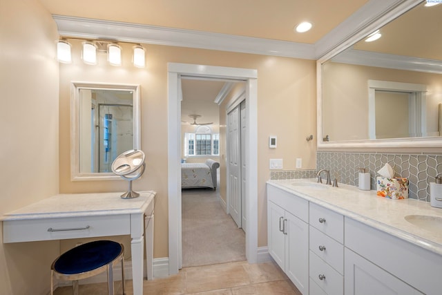 ensuite bathroom featuring a sink, recessed lighting, crown molding, double vanity, and decorative backsplash