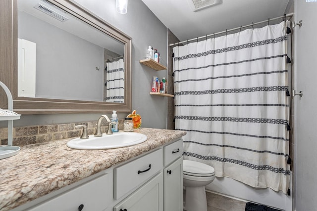 full bathroom with vanity, toilet, and shower / bath combo with shower curtain