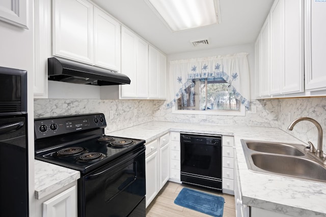 kitchen with white cabinetry, sink, decorative backsplash, and black appliances