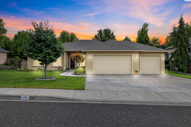439 Cherry Blossom Loop, Richland, WA 99352 - view of front of home with an attached garage, a yard, concrete driveway, and stucco siding