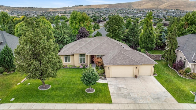 439 Cherry Blossom Loop, Richland, WA 99352 - view of front of property featuring an attached garage, concrete driveway, a front lawn, and stucco siding