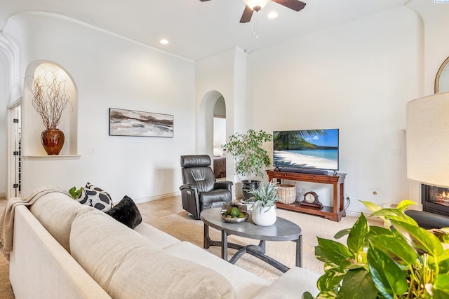439 Cherry Blossom Loop, Richland, WA 99352 - living area featuring arched walkways, ceiling fan, recessed lighting, and a glass covered fireplace