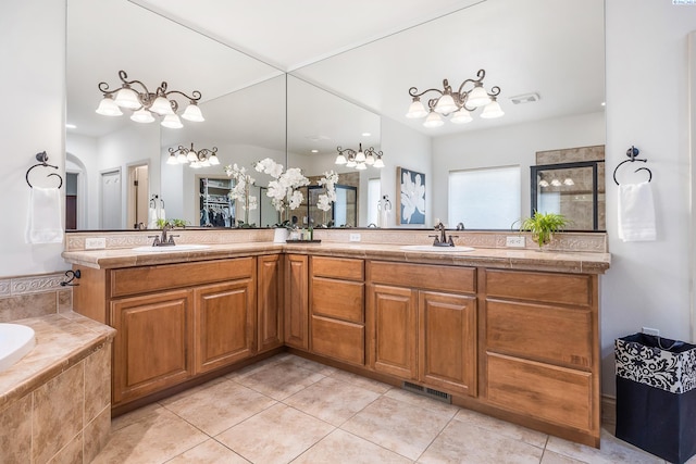 439 Cherry Blossom Loop, Richland, WA 99352 - bathroom with tile patterned flooring, a chandelier, double vanity, and a bath