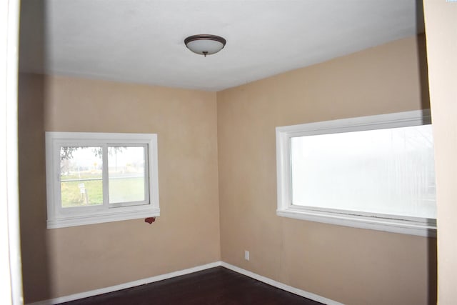 spare room featuring dark wood-type flooring