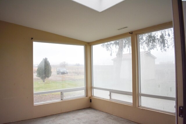 unfurnished sunroom featuring lofted ceiling