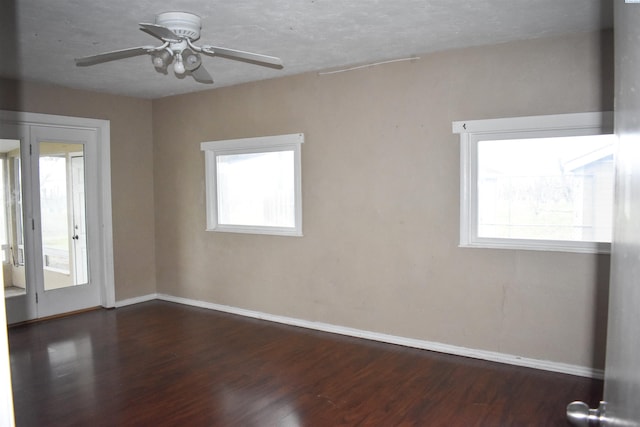 empty room with ceiling fan and dark wood-type flooring