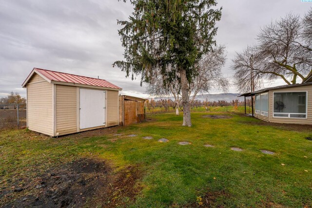 view of yard with a mountain view and a storage unit