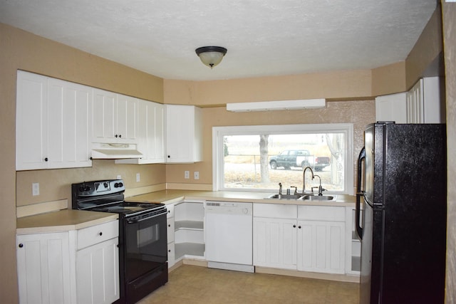 kitchen with white cabinets, sink, black appliances, and a textured ceiling