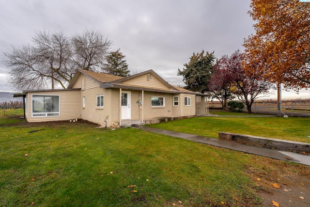 rear view of house with a lawn