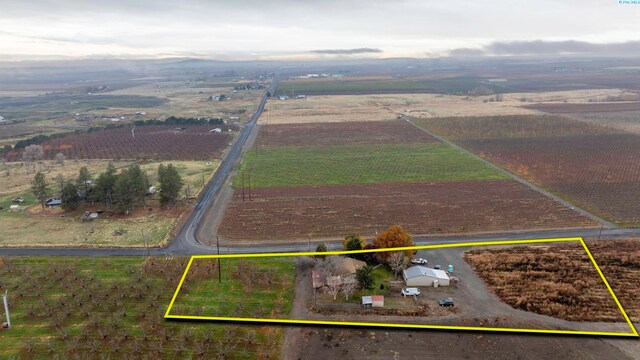 birds eye view of property with a rural view