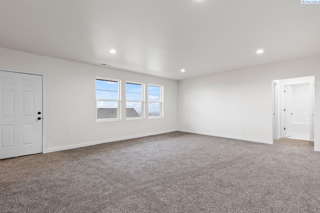 unfurnished living room featuring carpet floors