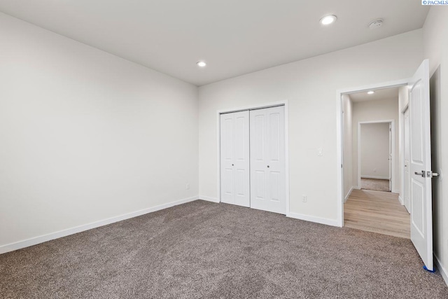 unfurnished bedroom featuring carpet and a closet