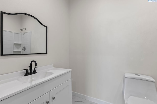 bathroom featuring vanity and toilet