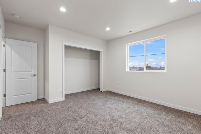 unfurnished bedroom featuring a closet and carpet flooring