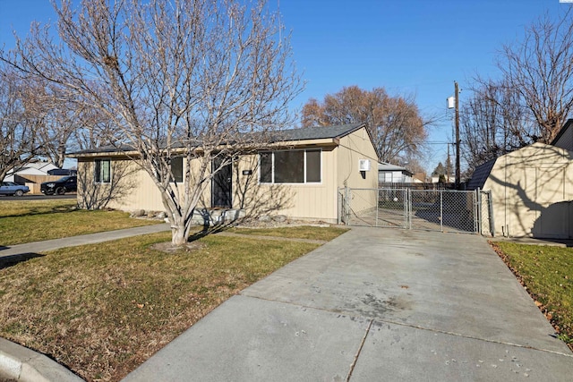 view of front of home with a front yard and a storage shed