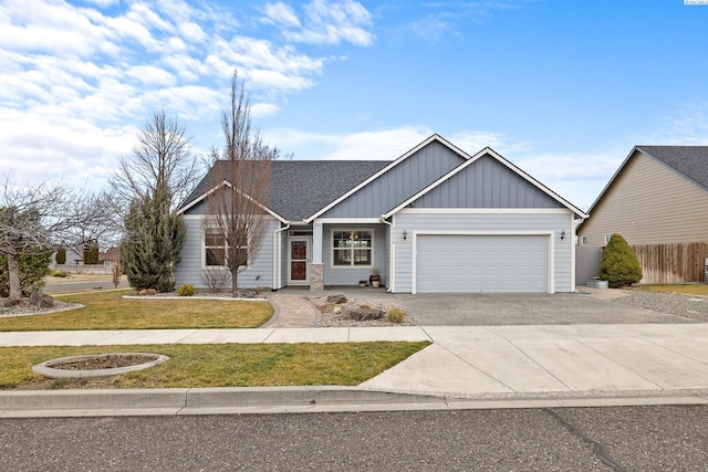 ranch-style house featuring aphalt driveway, an attached garage, fence, a front lawn, and board and batten siding