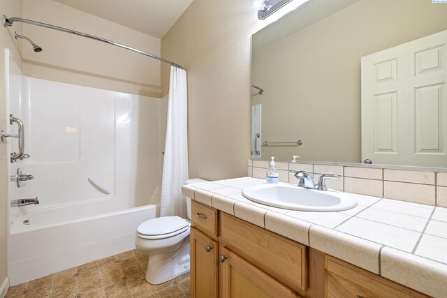 bathroom with toilet, shower / bathtub combination with curtain, and vanity