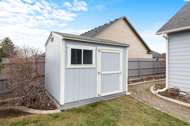 view of shed featuring fence