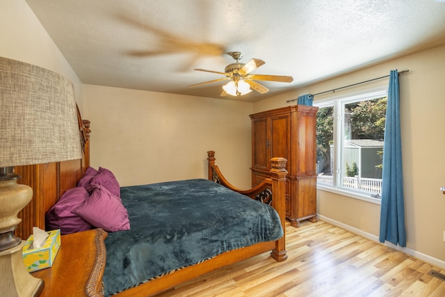 485 NW Thomas St, Pullman, WA 99163 - bedroom with light wood-type flooring, a ceiling fan, baseboards, and a textured ceiling