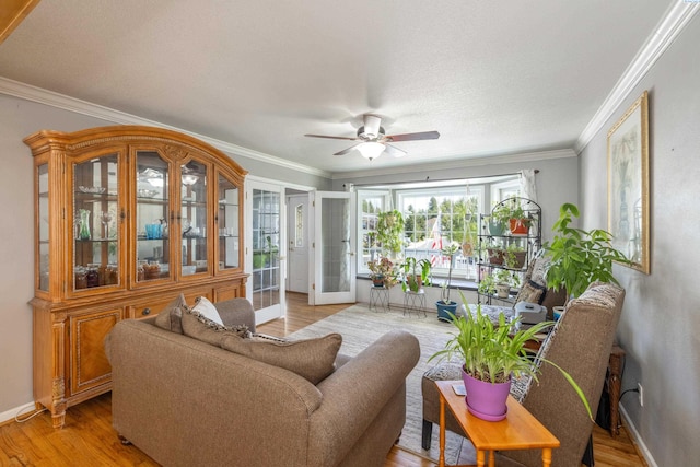 485 NW Thomas St, Pullman, WA 99163 - living area with a ceiling fan, ornamental molding, baseboards, and light wood-style floors